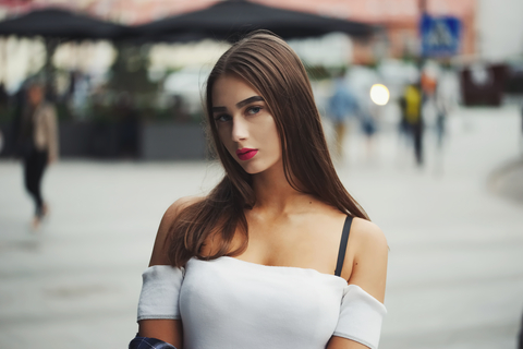 Portrait of beautiful brunette girl on the street