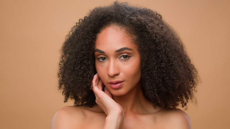 Female beauty portrait African American ethnic woman model beautiful attractive girl with perfect smooth skin thanks to dermaplane facial