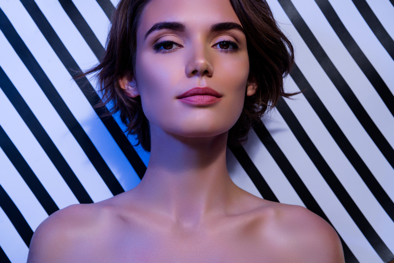 Photo of lovely stunning lady hypnotic tempting look long eyelashes open shoulders on striped color background.