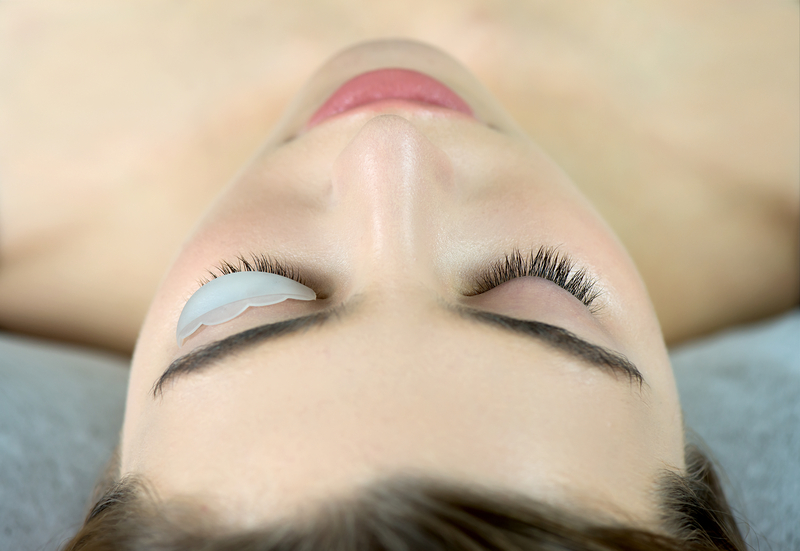 Eyelash Care Treatment: eyelash lifting, staining, curling, laminating and extension for lashes. Close up of beauty model`s face with perfect fresh skin and long eyelashes, lash lift laminate botox procedure. Skincare, Spa and Wellness