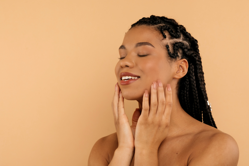 Facial Skincare. Portrait Of Happy African Female Touching Face Caring For Perfect Smooth Skin Posing With Eyes Closed